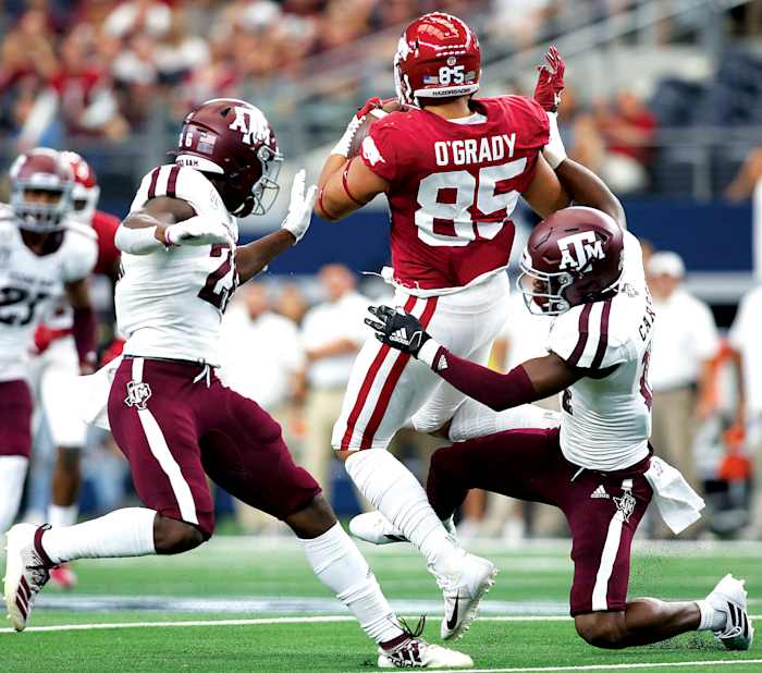 Arkansas Razorbacks tight end Cheyenne O'Grady (85) catches a pass against Texas A&M Aggies defensive back Demani Richardson (26) and defensive back Keldrick Carper (14) in the second quarter at AT&T Stadium.